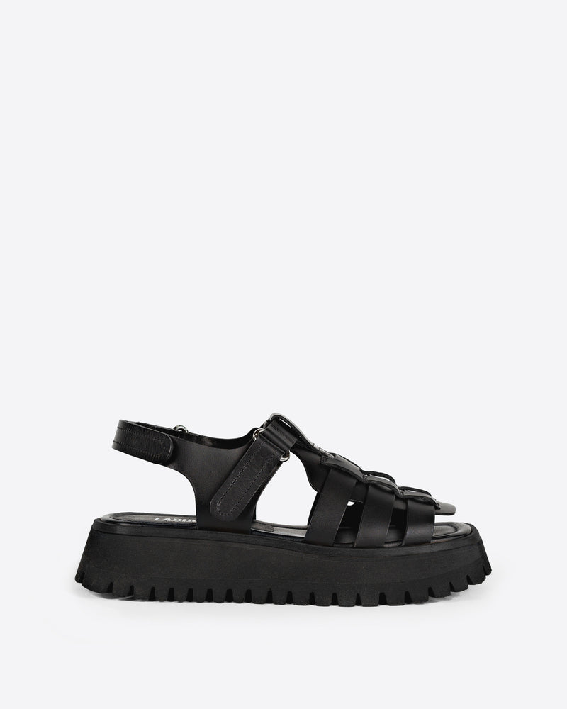 Black sandal with thick sole on a white background