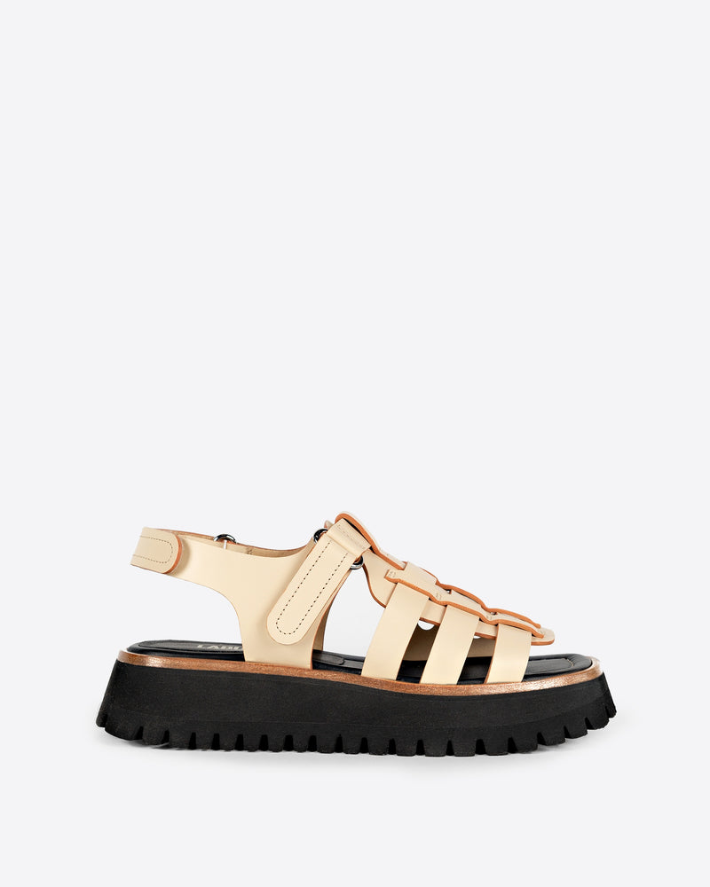 Cream sandal with a black chunky sole on a white background