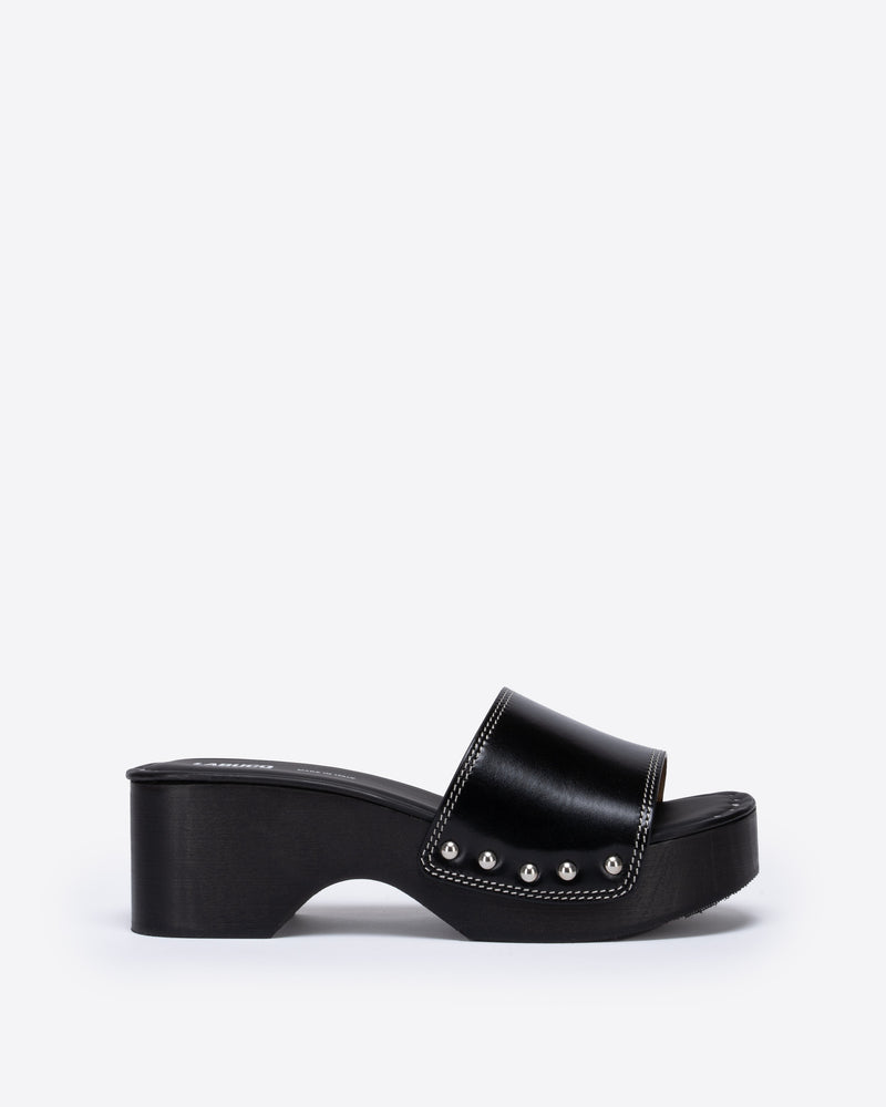 Black wooden clog with a black strap on a white background.