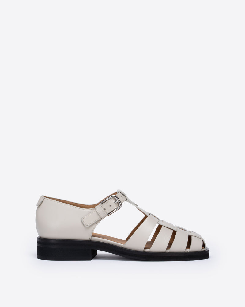 White sandal with a black sole on a white background